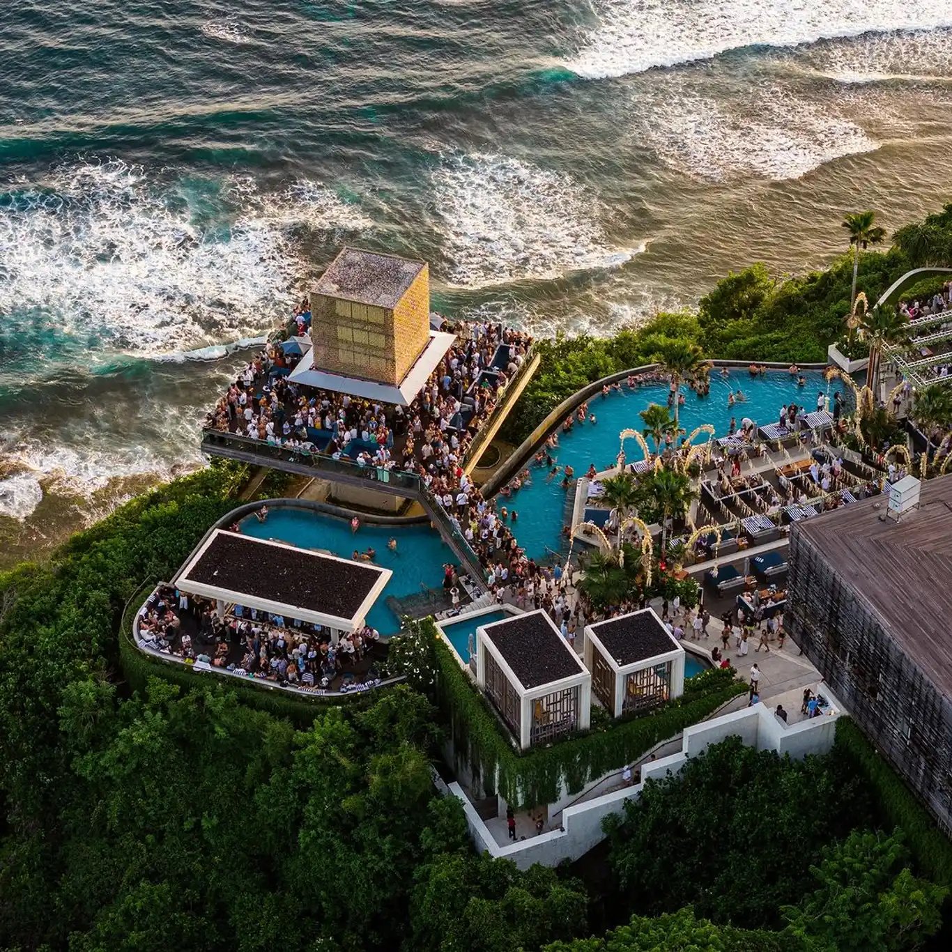 Savaya Uluwatu — infinity pool ja kalju serval ulatuv klaaskuup The Cube päevasel ajal.